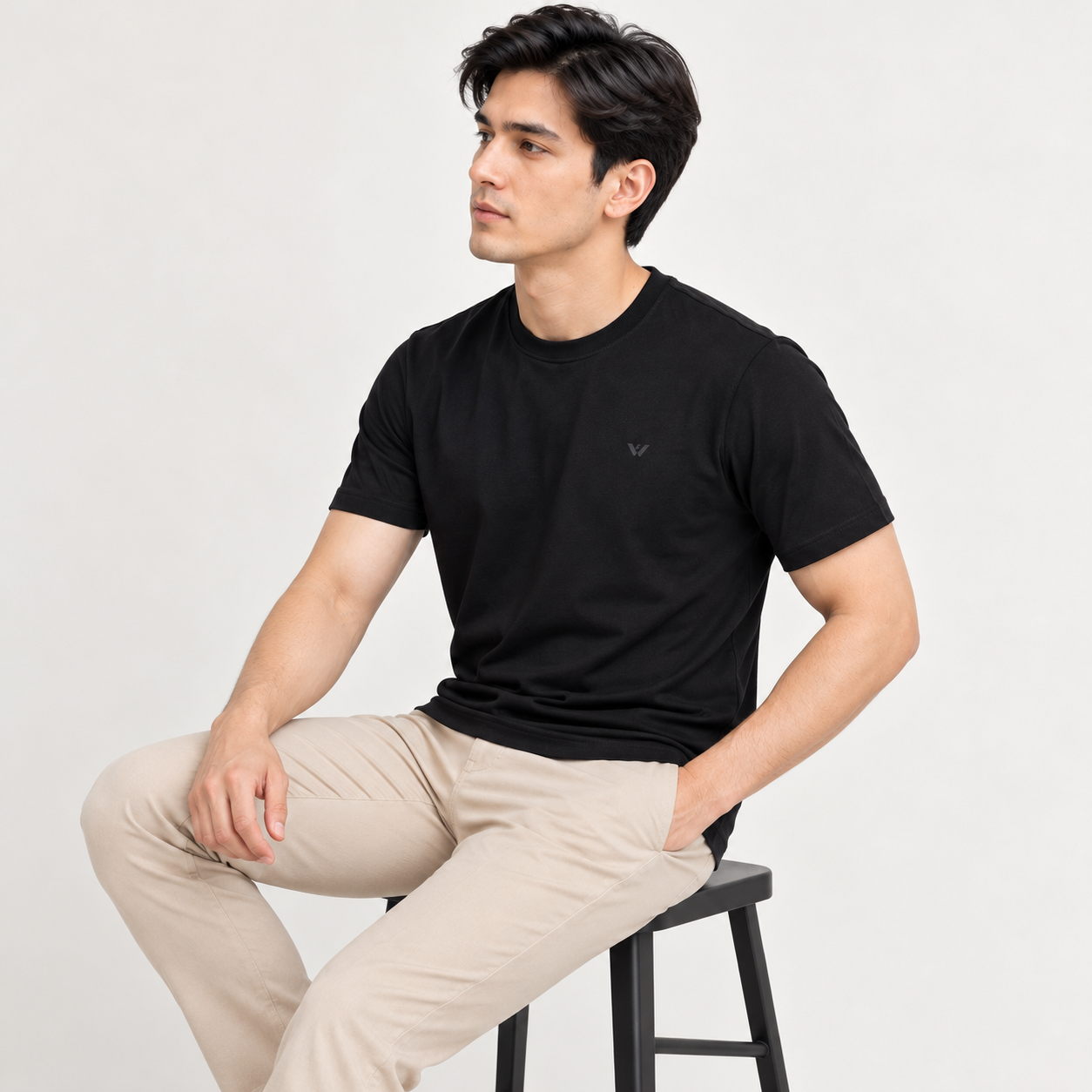 minimalist_studio_portrait_of_a_seated_man.png
